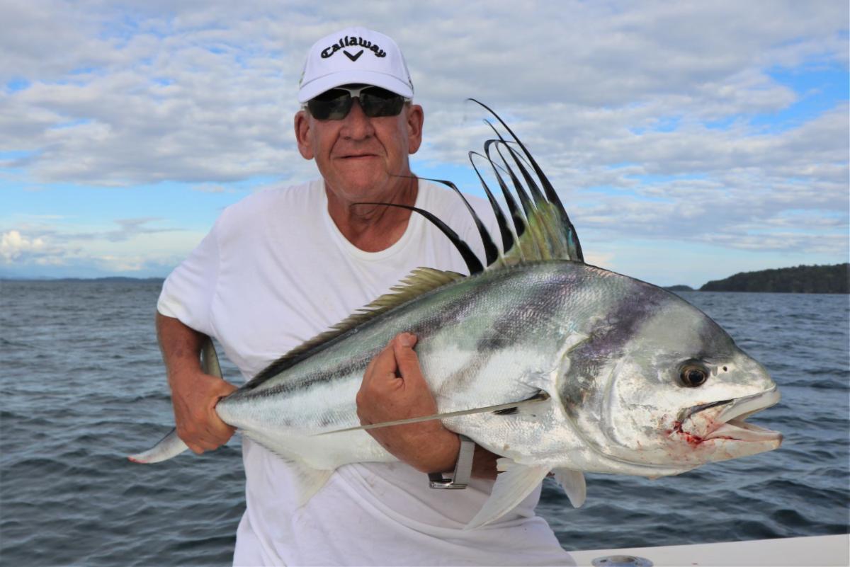Angler posing with rooster fish
