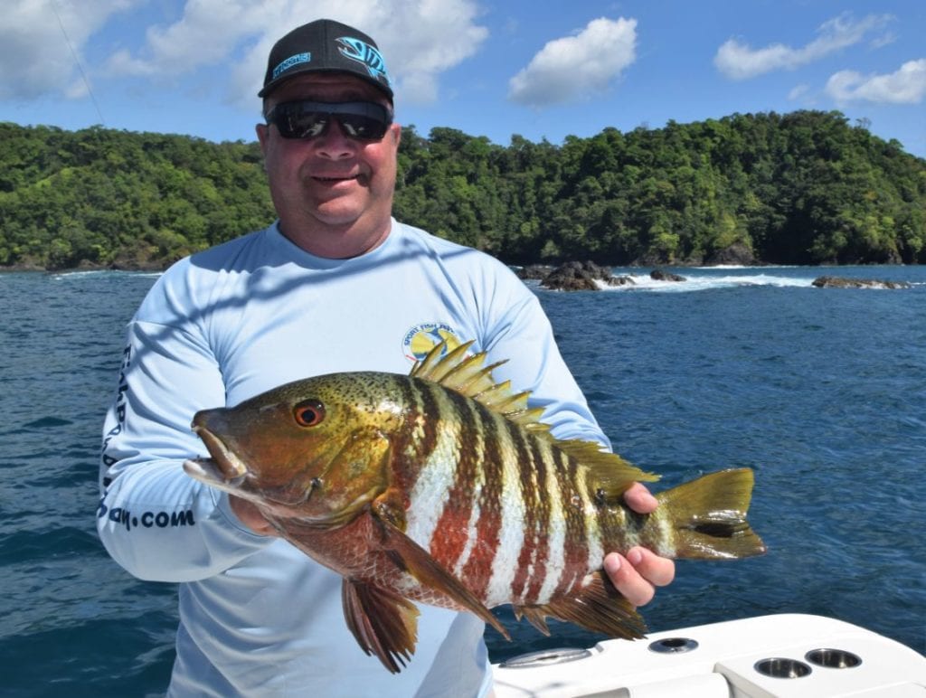Angler posing with Mexican Barred Snapper Isla Parida in background