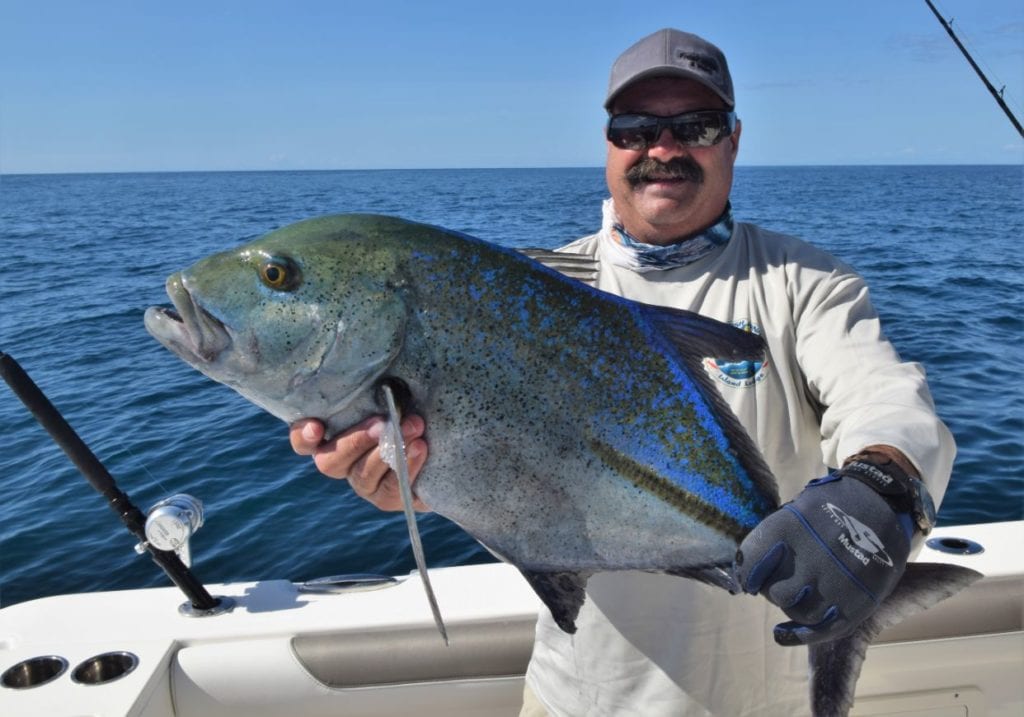 Angler holding Bluefin Trevally 
