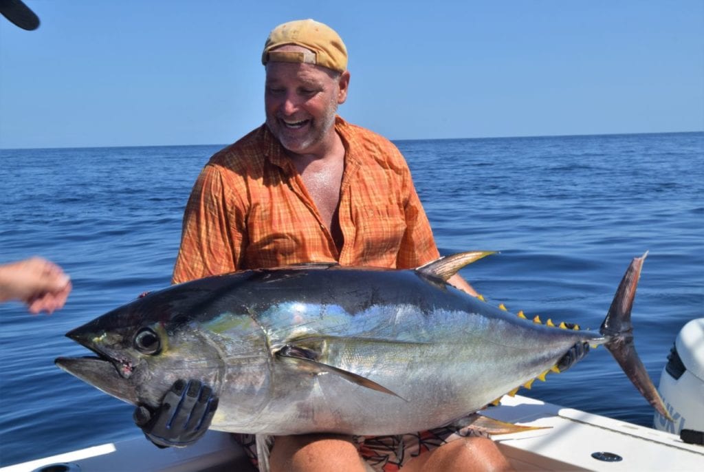Angler holding yellowfin tuna for picture