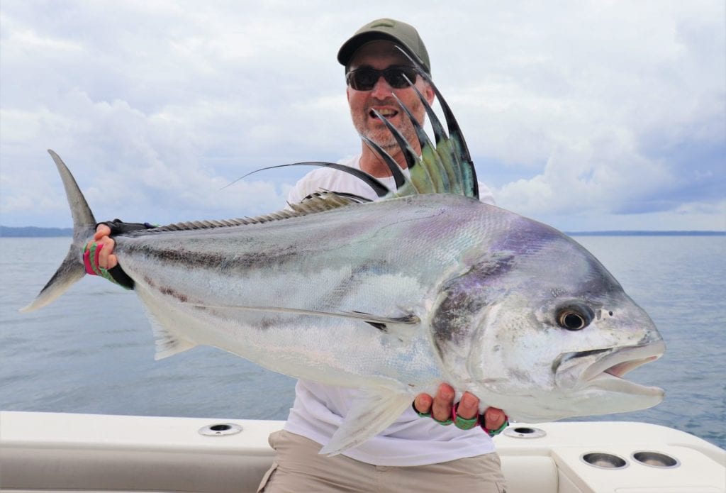 Angler at Sport Fish Panama Island Lodge posing with large roosterfish
