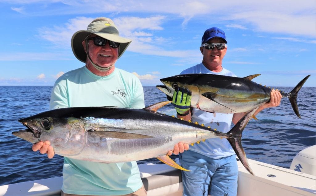 Two angles posing with yellowfin tuna