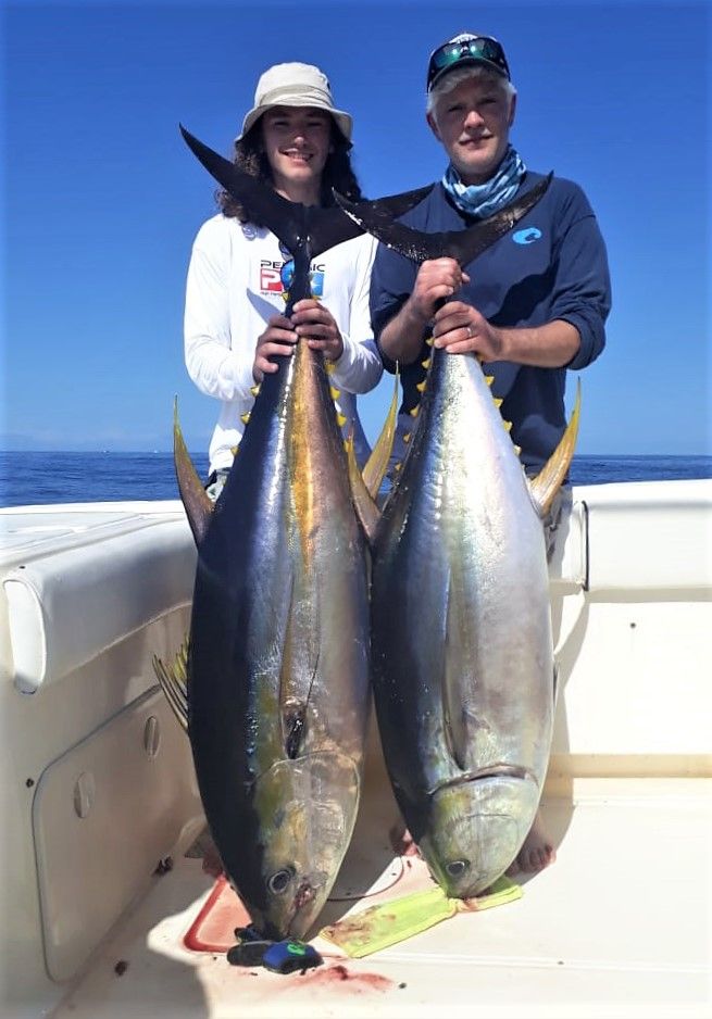 Husband and wife fishing team posing with yellowfin tuna while fishing at Sport Fish Panama Island Lodge