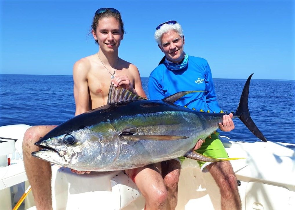 Two anglers posing with medium sized yellowfin tuna while fishing at Sport Fish Panama Island Lodge