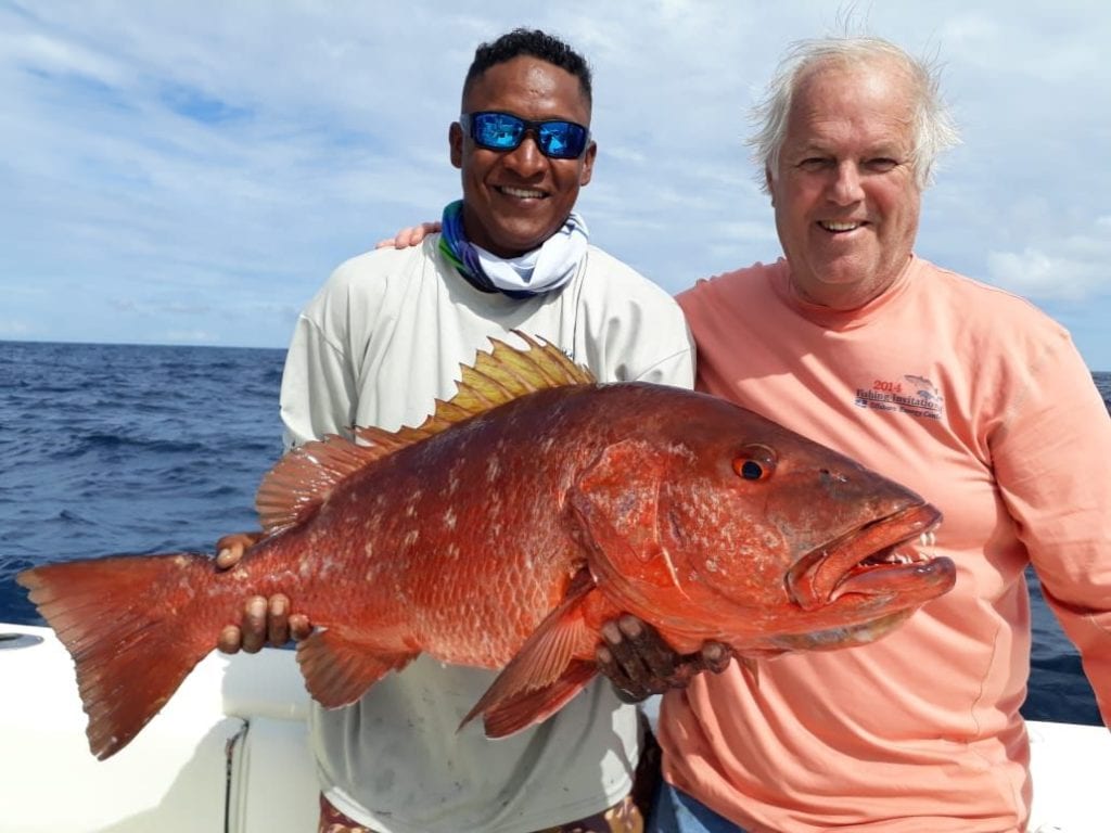 Mate and angler posing with cuber snapper