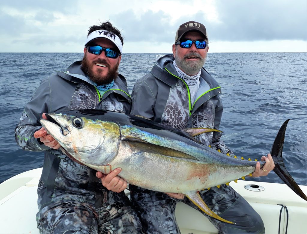 2 anglers holding tuna