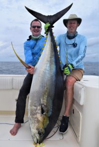 Two anglers posing with monster tuna