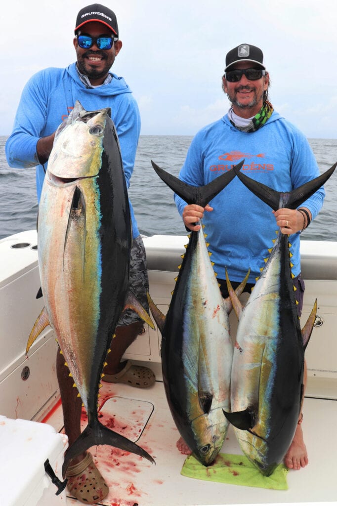 Mate and angler Jay posing with 3 yellowfin tunas