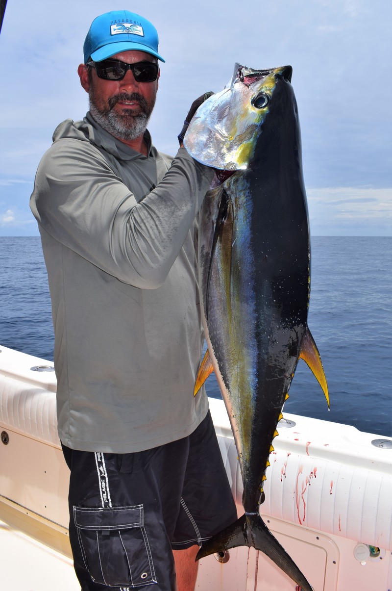 Man with beard holding yellowfin tuna