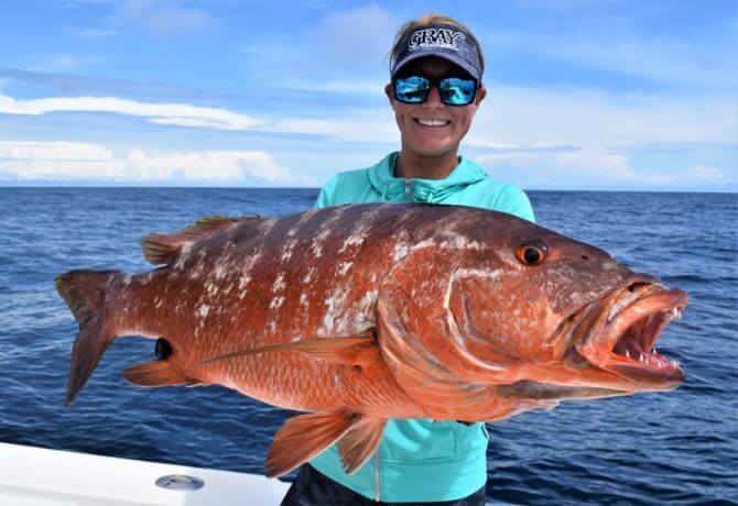 Lady angler holding cubera snapper Sport Fish Panama Island Lodge