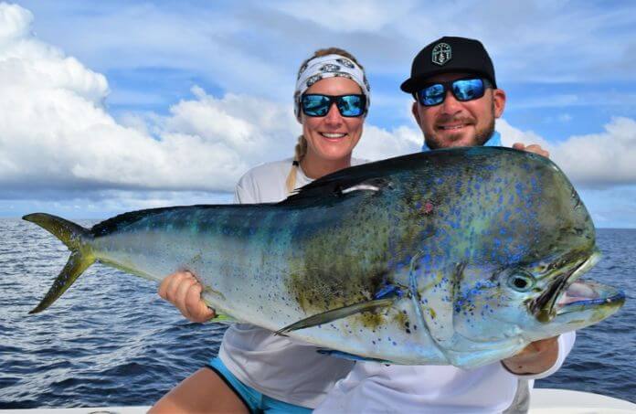 Angling couple posing with Dorado, also known as ‘Mahi-Mahi’ or ‘Dolphin’