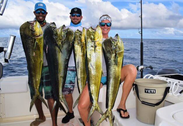 Mate and clients at Sport Fish Panama Island Lodge posing with dorados