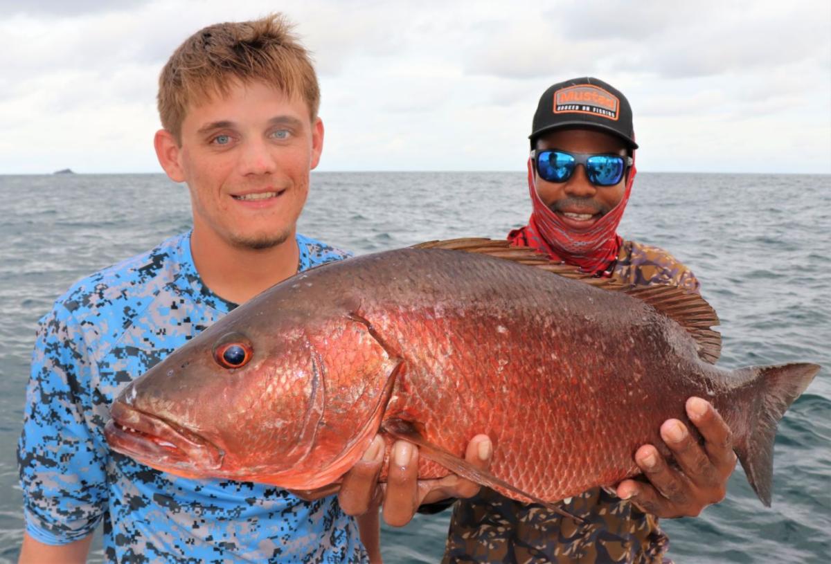 Mate holding cubera snapper with Isla Montuosa in background