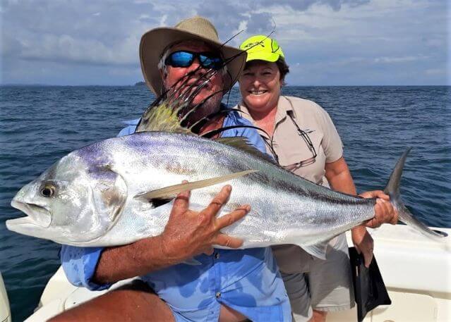 Angling couple posing with roosterfish.