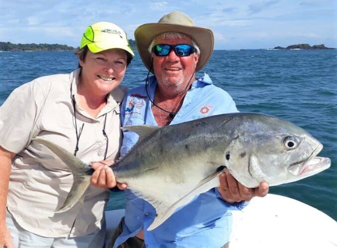 Angling couple posing with Jack Crevalle. small Panama islands in background