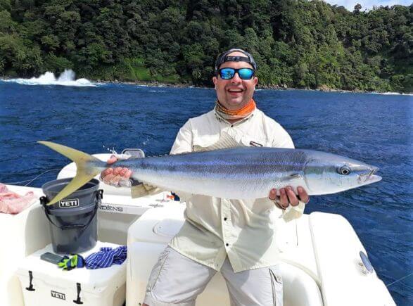 angler posing with rainbow runner. Sport Fish Panama Island Lodge
