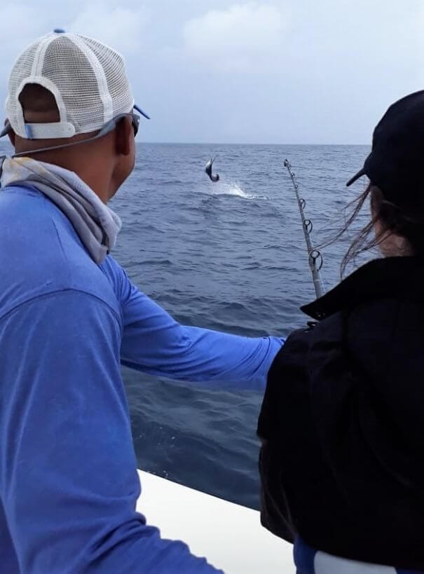 Female angler fighting jumping Pacific Sailfish or 'Pez Vela'