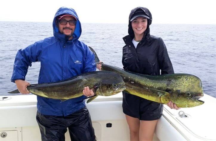 Father daughter fishing team posing with Dorado, also known as ‘Mahi-Mahi’ or ‘Dolphin’