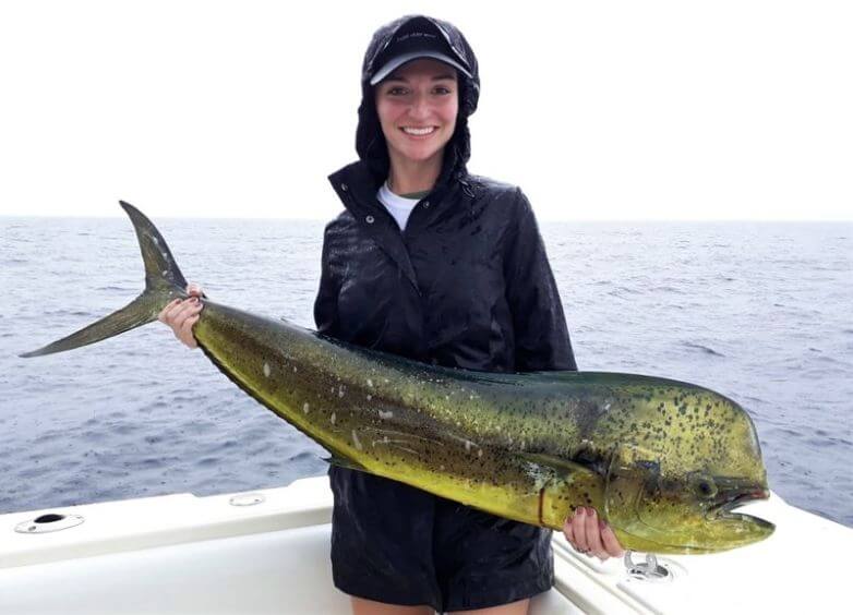 Attractive lady angler posing with Dorado, also known as ‘Mahi-Mahi’ or ‘Dolphin’
