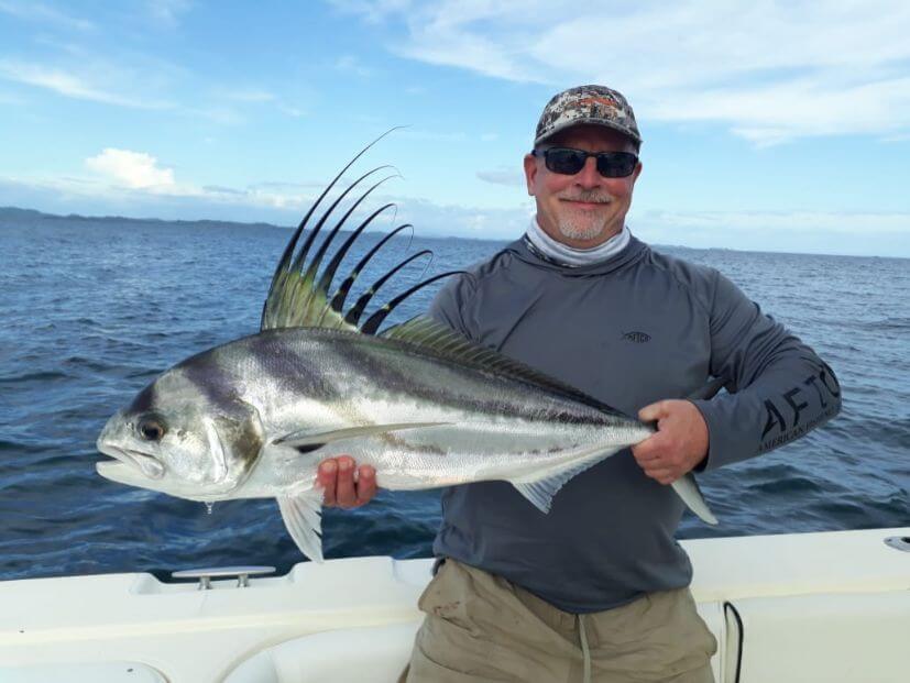 Angler posing with roosterfish.   Isla Parida, Panama in the background.