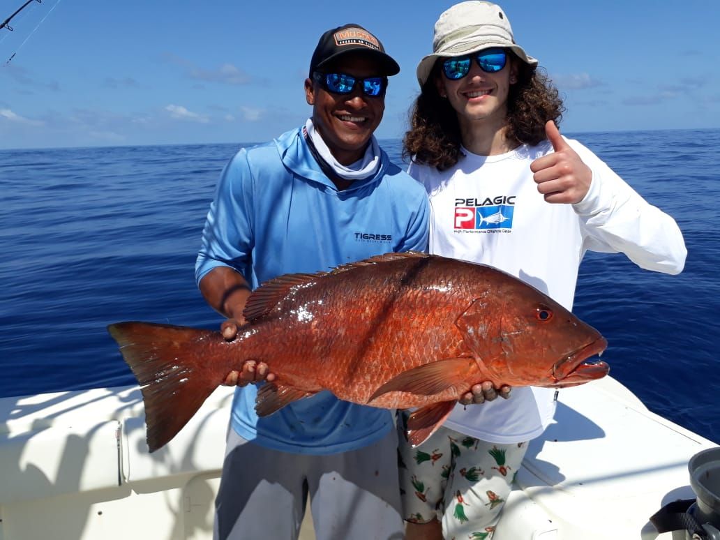 Angler and mate posing with cubera snapper